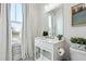 Well-lit bathroom featuring a vanity, window, and toilet at 642 Stickley Oak Way, Woodstock, GA 30189