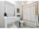 Well-lit bathroom with shower-tub combo, framed mirror, and vanity with cabinets at 642 Stickley Oak Way, Woodstock, GA 30189