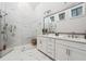 Luxurious bathroom with double vanity, a frameless glass shower, and elegant marble-style tile, for a spa-like experience at 642 Stickley Oak Way, Woodstock, GA 30189