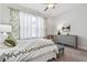 Bright bedroom featuring floral curtains, ceiling fan, and neutral color scheme at 642 Stickley Oak Way, Woodstock, GA 30189