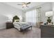 Bright bedroom featuring floral curtains, ceiling fan, and neutral color scheme at 642 Stickley Oak Way, Woodstock, GA 30189