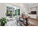 Dining area with a wooden table and chairs with large sliding glass doors leading to a private outdoor patio at 642 Stickley Oak Way, Woodstock, GA 30189
