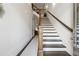Inviting entryway with staircase and wood railing at 642 Stickley Oak Way, Woodstock, GA 30189