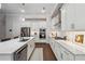Bright kitchen with stainless steel appliances, white cabinets, and hardwood floors at 642 Stickley Oak Way, Woodstock, GA 30189