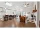 Bright open-concept living space with hardwood floors, modern fixtures, fireplace, and a kitchen with stainless steel appliances at 642 Stickley Oak Way, Woodstock, GA 30189