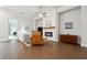Elegant living room featuring hardwood floors, fireplace, a ceiling fan, and comfortable seating, creating a welcoming atmosphere at 642 Stickley Oak Way, Woodstock, GA 30189