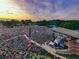 Aerial view of large outdoor concert with stage and crowd at sunset at 642 Stickley Oak Way, Woodstock, GA 30189