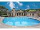 Inviting community swimming pool surrounded by lounge chairs and lush landscaping at 642 Stickley Oak Way, Woodstock, GA 30189