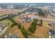 Expansive aerial view of a residence with a private backyard, complemented by mature trees and established landscaping at 1305 Lanier Ct, Hampton, GA 30228