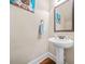 Bathroom featuring a pedestal sink, stained wood floors and an ornate mirror at 1305 Lanier Ct, Hampton, GA 30228