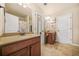 Bright bathroom with double sinks, neutral tile flooring and modern lighting fixtures at 1305 Lanier Ct, Hampton, GA 30228