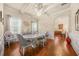 Bright dining room with modern lighting, hardwood floors, and adjacent kitchen view at 1305 Lanier Ct, Hampton, GA 30228