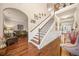 Grand foyer with hardwood floors, a staircase with wooden railing, and decorative accents at 1305 Lanier Ct, Hampton, GA 30228