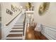 Grand foyer with staircase, hardwood floors, and elegant decor at 1305 Lanier Ct, Hampton, GA 30228