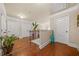 Upstairs hallway featuring wood floors, natural light, and a decorative plant at 1305 Lanier Ct, Hampton, GA 30228