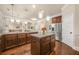 Spacious kitchen boasts a large island, stainless steel appliances, and hardwood floors at 1305 Lanier Ct, Hampton, GA 30228