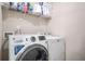 Laundry room featuring front loading washer and dryer, and overhead storage at 1305 Lanier Ct, Hampton, GA 30228