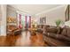 Cozy living room with hardwood floors, comfortable seating, and natural light from the windows at 1305 Lanier Ct, Hampton, GA 30228