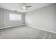 Carpeted bedroom features a ceiling fan and a window with blinds for natural light at 1501 Clairmont Rd # 1624, Decatur, GA 30033