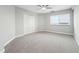 Bright bedroom featuring plush carpet, a modern ceiling fan, neutral walls, and a large window for natural light at 1501 Clairmont Rd # 1624, Decatur, GA 30033