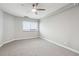 Bright bedroom featuring neutral carpet and walls, a modern ceiling fan, and a large window for natural light at 1501 Clairmont Rd # 1624, Decatur, GA 30033