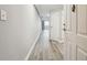 Bright condo hallway with gray walls and wood-look flooring leading to a balcony at 1501 Clairmont Rd # 1624, Decatur, GA 30033