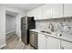 Updated apartment kitchen with stainless steel refrigerator and modern tile backsplash at 1501 Clairmont Rd # 1624, Decatur, GA 30033