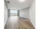 Bright living room with wood-look flooring and sliding glass doors to a balcony with a view at 1501 Clairmont Rd # 1624, Decatur, GA 30033