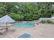 Community pool featuring lounge chairs and umbrellas surrounded by a deck at 1905 Countryside Se Pl # 1905, Smyrna, GA 30080