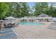 Community pool featuring lounge chairs and umbrellas surrounded by a deck at 1905 Countryside Se Pl # 1905, Smyrna, GA 30080