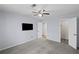 Spacious main bedroom with ceiling fan, neutral carpet, and a mounted TV at 1905 Countryside Se Pl # 1905, Smyrna, GA 30080