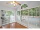 Sunroom features hardwood floors and large windows with wooded view at 1905 Countryside Se Pl # 1905, Smyrna, GA 30080