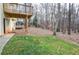 Backyard view showing grass, wooded area, and deck at 1975 Skidmore Cir, Lawrenceville, GA 30044