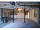 Large unfinished basement space with support beams and concrete floor at 1975 Skidmore Cir, Lawrenceville, GA 30044