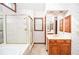 Bright bathroom featuring wallpaper, shower stall, vanity, and natural light at 1975 Skidmore Cir, Lawrenceville, GA 30044