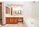 Bright bathroom featuring wallpaper, vanity, soaking tub, and recessed lighting at 1975 Skidmore Cir, Lawrenceville, GA 30044