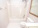 Bright bathroom featuring shower, tub, toilet, and natural light at 1975 Skidmore Cir, Lawrenceville, GA 30044