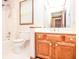 Bathroom featuring oak vanity, tub, shower, and natural light at 1975 Skidmore Cir, Lawrenceville, GA 30044