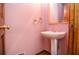 Charming pedestal sink and vintage fixtures add character to this cozy powder room at 1975 Skidmore Cir, Lawrenceville, GA 30044