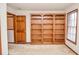 Bedroom with carpet, a window with blinds, and a large built-in wooden bookcase at 1975 Skidmore Cir, Lawrenceville, GA 30044