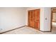 Bedroom featuring carpet, baseboard trim, and closet with shutter doors at 1975 Skidmore Cir, Lawrenceville, GA 30044