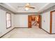 Bright carpeted bedroom featuring a ceiling fan, wallpaper border, and wood trim at 1975 Skidmore Cir, Lawrenceville, GA 30044