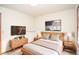 Staged bedroom featuring bed, dresser, natural light, and neutral palette at 1975 Skidmore Cir, Lawrenceville, GA 30044