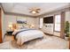 Stylishly staged bedroom with a ceiling fan, large windows, and a plush rug at 1975 Skidmore Cir, Lawrenceville, GA 30044