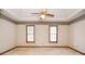 This bedroom features a ceiling fan, natural light, and a floral wallpaper border at 1975 Skidmore Cir, Lawrenceville, GA 30044