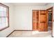 Neutral bedroom with carpet, wood trim, open closet, and natural light at 1975 Skidmore Cir, Lawrenceville, GA 30044