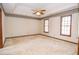 This bedroom includes carpeted floors, decorative wallpaper, and natural light from two windows at 1975 Skidmore Cir, Lawrenceville, GA 30044