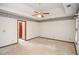 Spacious carpeted bedroom with decorative wallpaper, ceiling fan, and natural light at 1975 Skidmore Cir, Lawrenceville, GA 30044