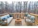 Wooden deck featuring chairs and sofas surrounded by peaceful wooded landscape at 1975 Skidmore Cir, Lawrenceville, GA 30044