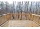 Wooden deck overlooks a beautiful wooded area with a railing on the perimeter at 1975 Skidmore Cir, Lawrenceville, GA 30044